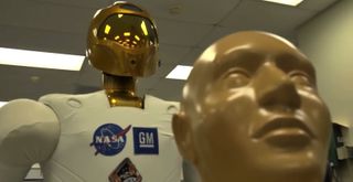 NASA's Robonaut 2 ground unit is seen with a mannequin during telemedicine training for ultrasound and injection tests. 