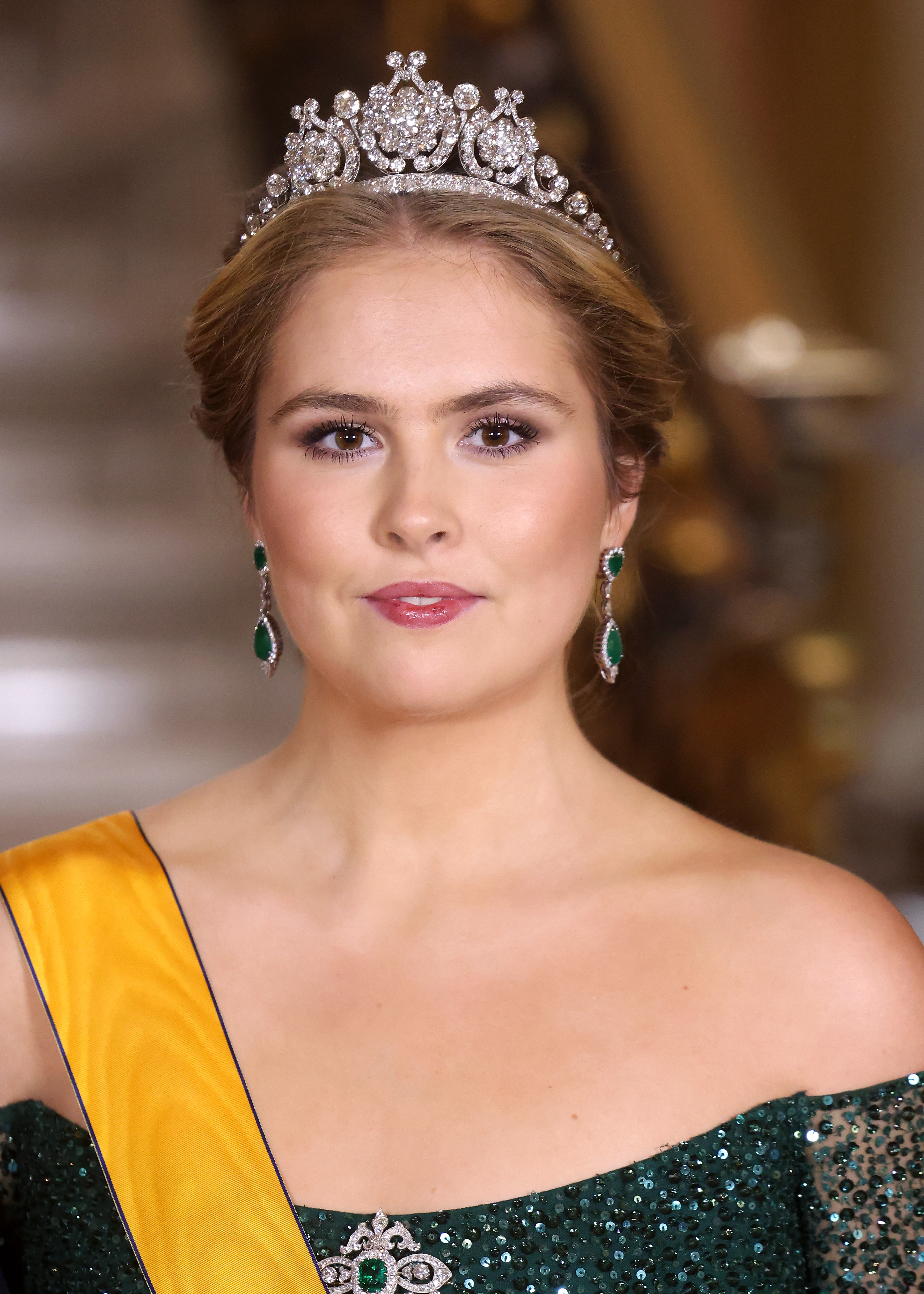 Princess Catharina-Amalia smiling and wearing a green sequin dress and tiara