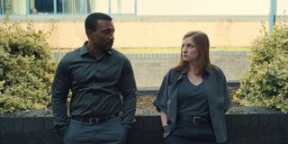 ashley walters as ds bascombe and Faye Marsay as DS Misha Frank dressed in grey and talking outside in a still from adolescence