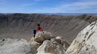 Meteor Crater in Arizona (formally called Barringer meteorite crater) viewed from the rim near the visitor center. The crater is nearly a mile across and the hole more than 550 feet deep.