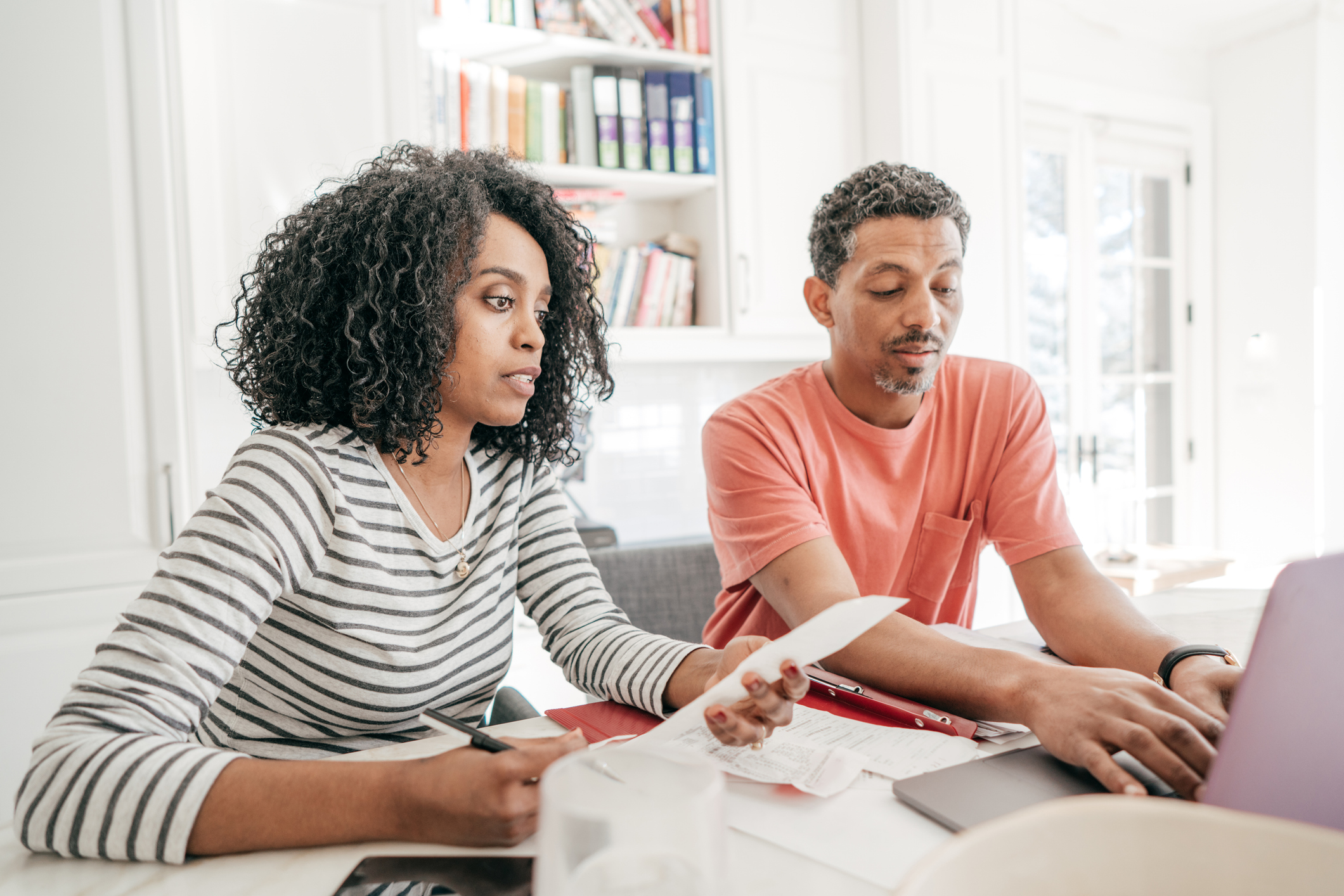 Financial planning in the kitchen with laptop