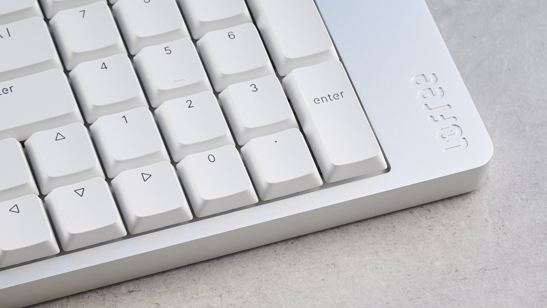 The Lofree Flow 2 on a stone surface with a blue background