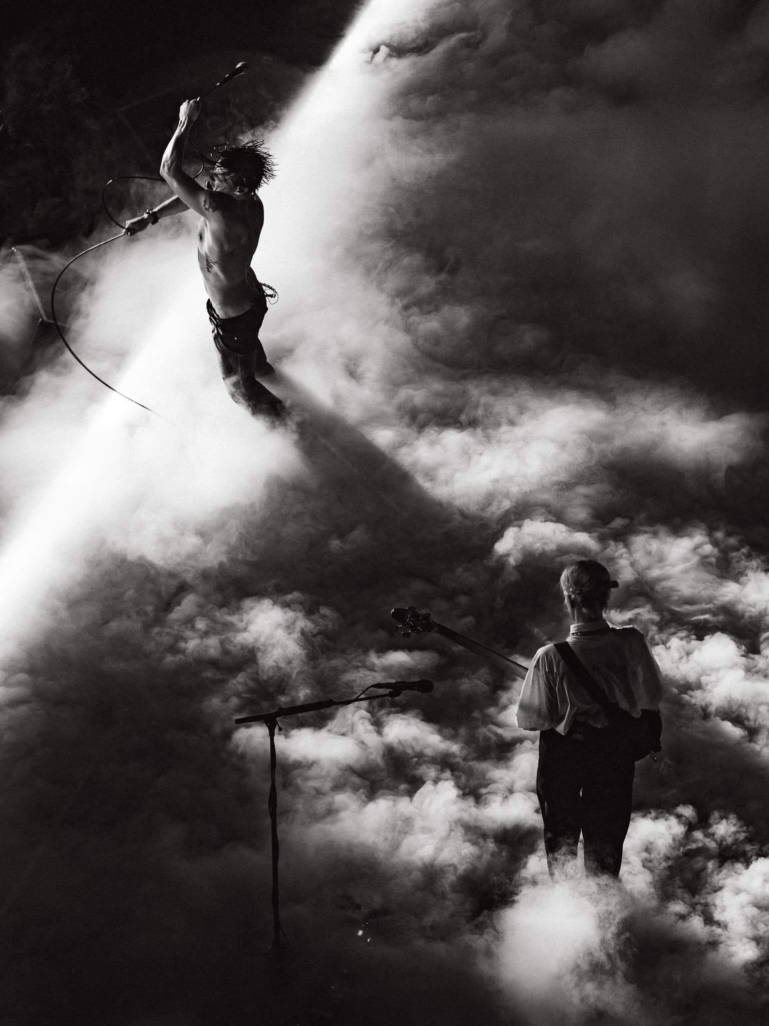Band performing on smoke-shrouded stage.