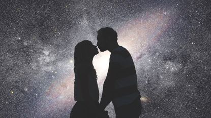 Silhouettes of a young couple under the starry sky.