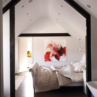 Attic room with bed and white walls