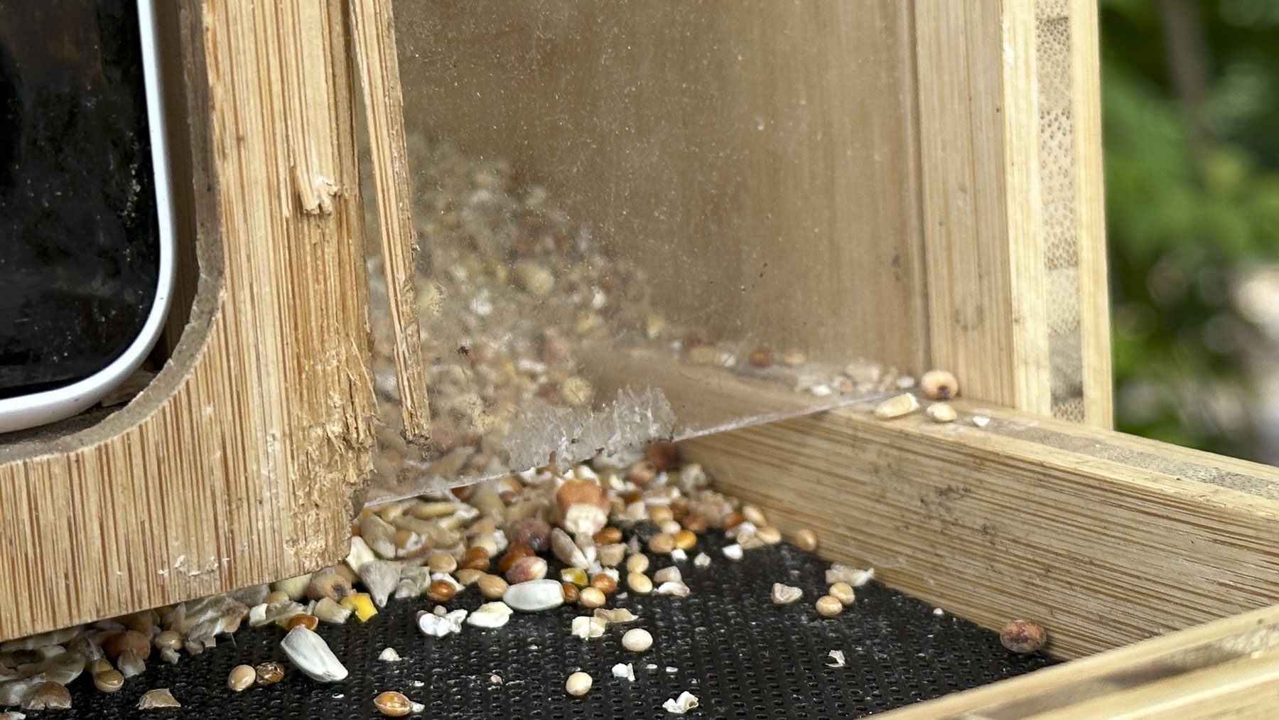 Netvue Birdfy Bamboo bird feeder camera closeup of damage caused by a squirrel