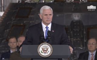 A man stands and looks strict at a podium