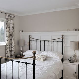 Neutral bedroom with wrought iron bed