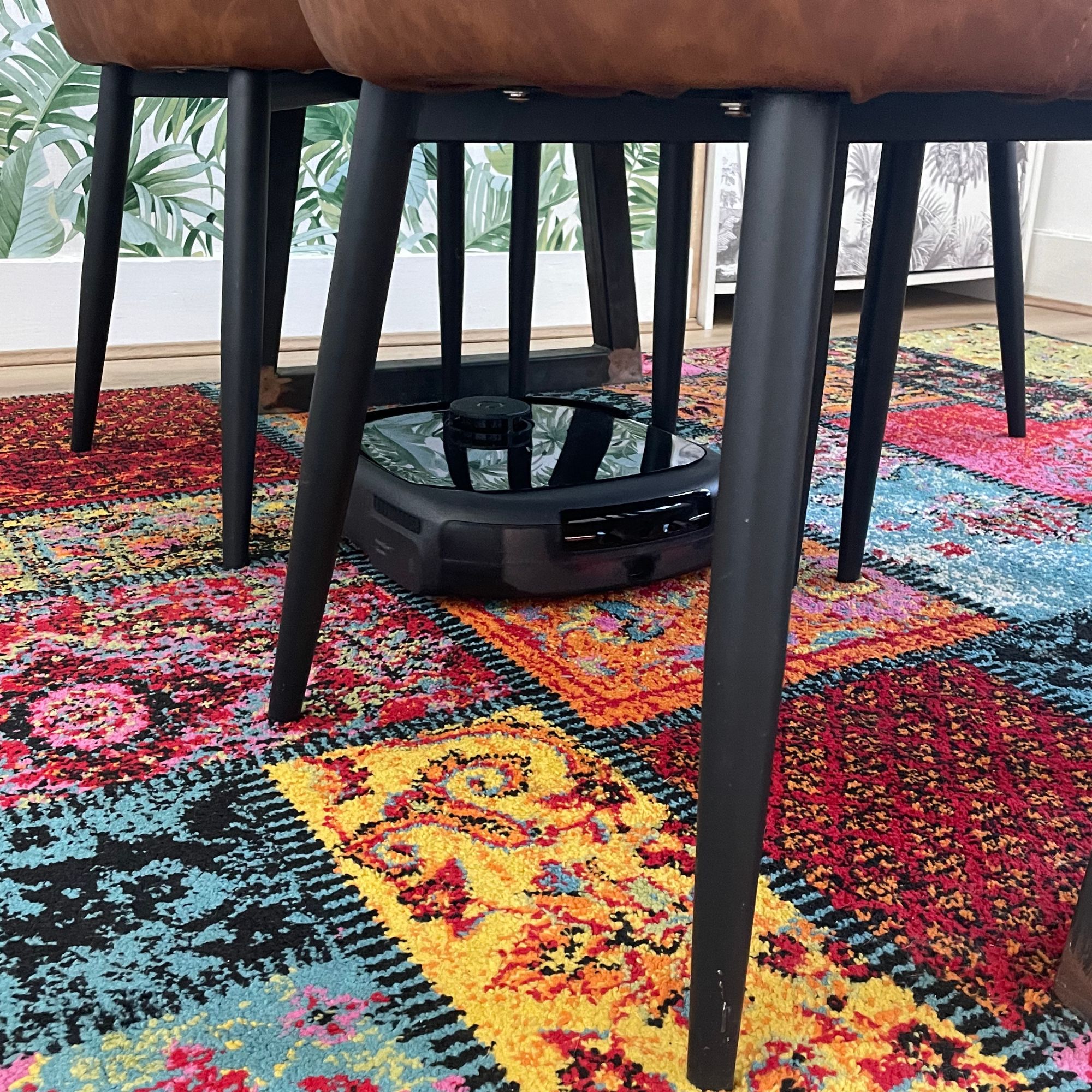 Eufy Robot Vacuum Omni E25  on a multi-coloured patchwork rug,