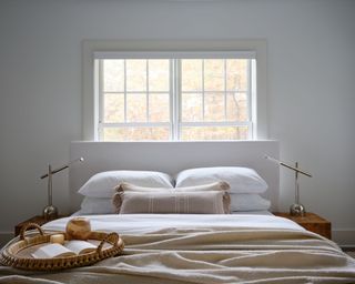 calming bedroom with white walls and neutral bedding