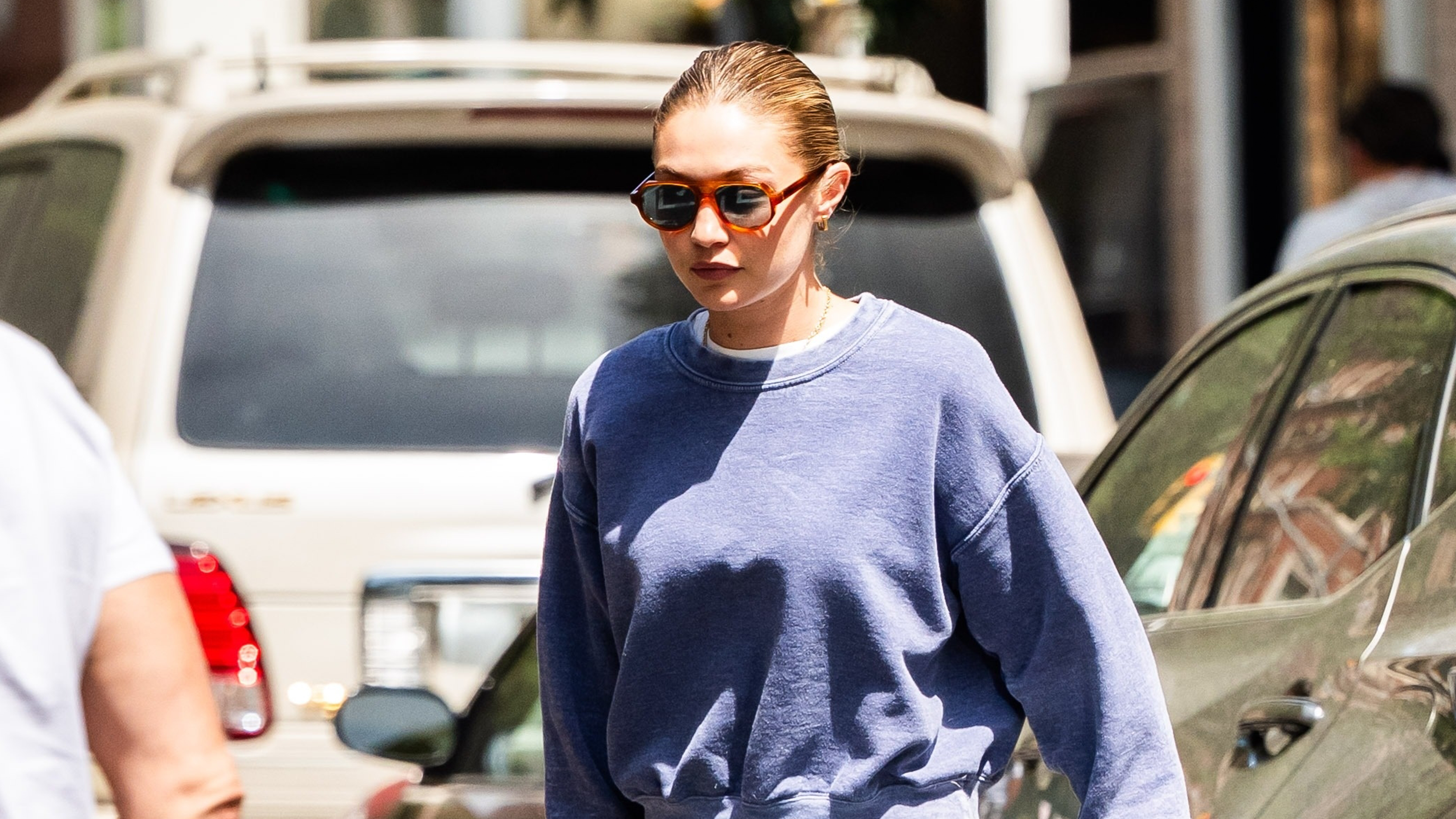 Gigi Hadid wearing a Loro Piana Loom Bag with Alaia fishnet flats in NYC