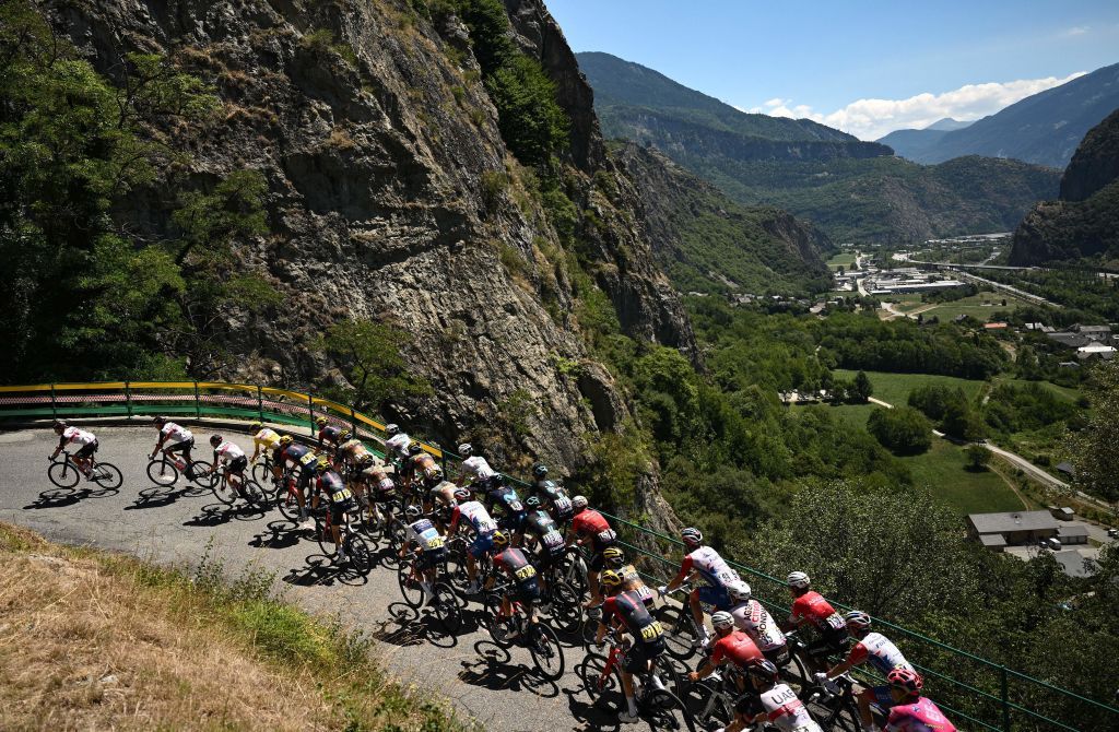 The pack of riders cycle in the ascent of Montvernier during the 11th stage of the 109th edition of the Tour de France cycling race 1517 km between Albertville and Col du Granon Serre Chevalier in the French Alps on July 13 2022 Photo by Marco BERTORELLO AFP Photo by MARCO BERTORELLOAFP via Getty Images
