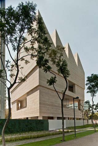 Exterior of Museo Jumex building with trees and grass 