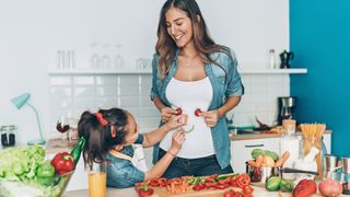 woman cooking with her daughter to support gut health