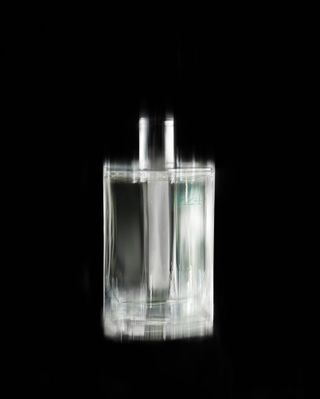 Hermes H24 perfume in clear glass bottle against black background