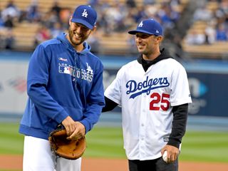 Max Homa talks with the LA Dodgers' Clayton Kershaw after throwing out the ceremonial first pitch before the game against the Washington Nationals at Dodger Stadium on May 10, 2019