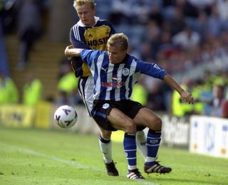 Sheffield Wednesday's Niclas Alexandersson is challenged by Tottenham's Steffen Iversen in a Premier League game in August 1999.