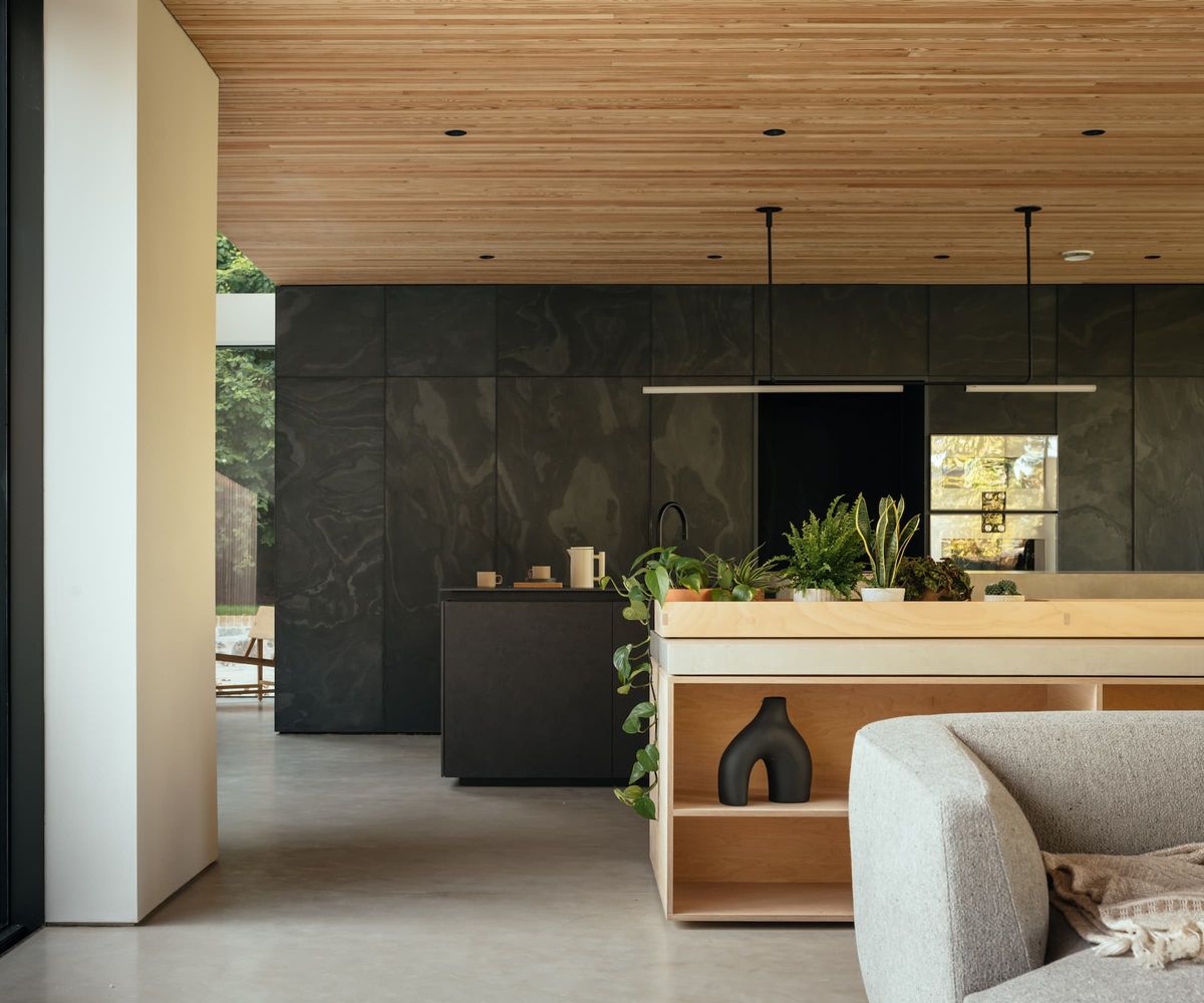 A kitchen-dining area with a wooden serving area dividing the room