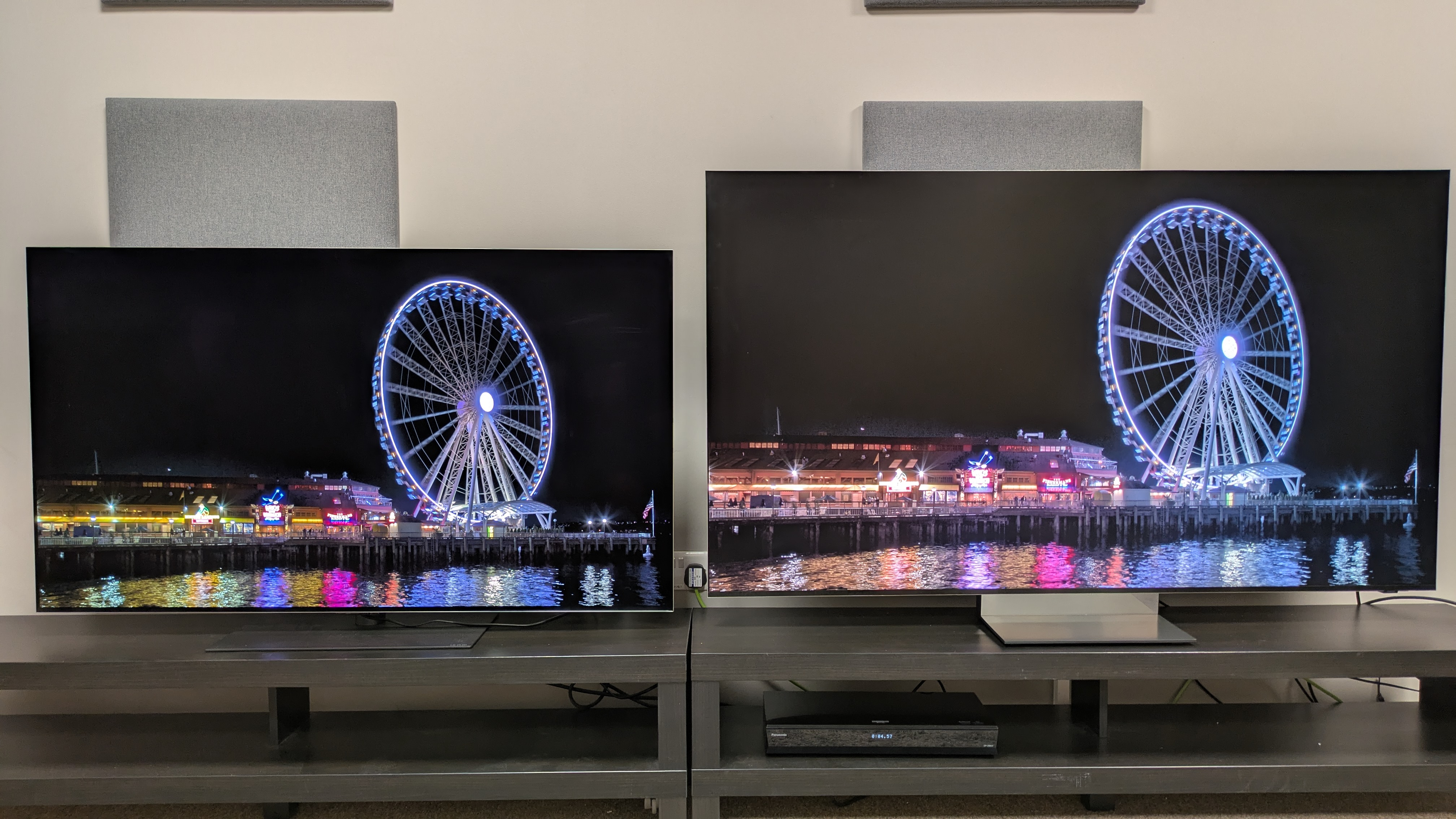 LG G6 (left) vs Samsung R95H (right) showing a Ferris wheel on a dark dock on screen. Both TVs deliver good brightness with deep black tones