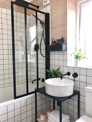 Crittal style shower screen with white basin and matt black fixtures