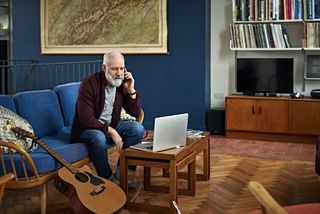 Man on phone at home in living room