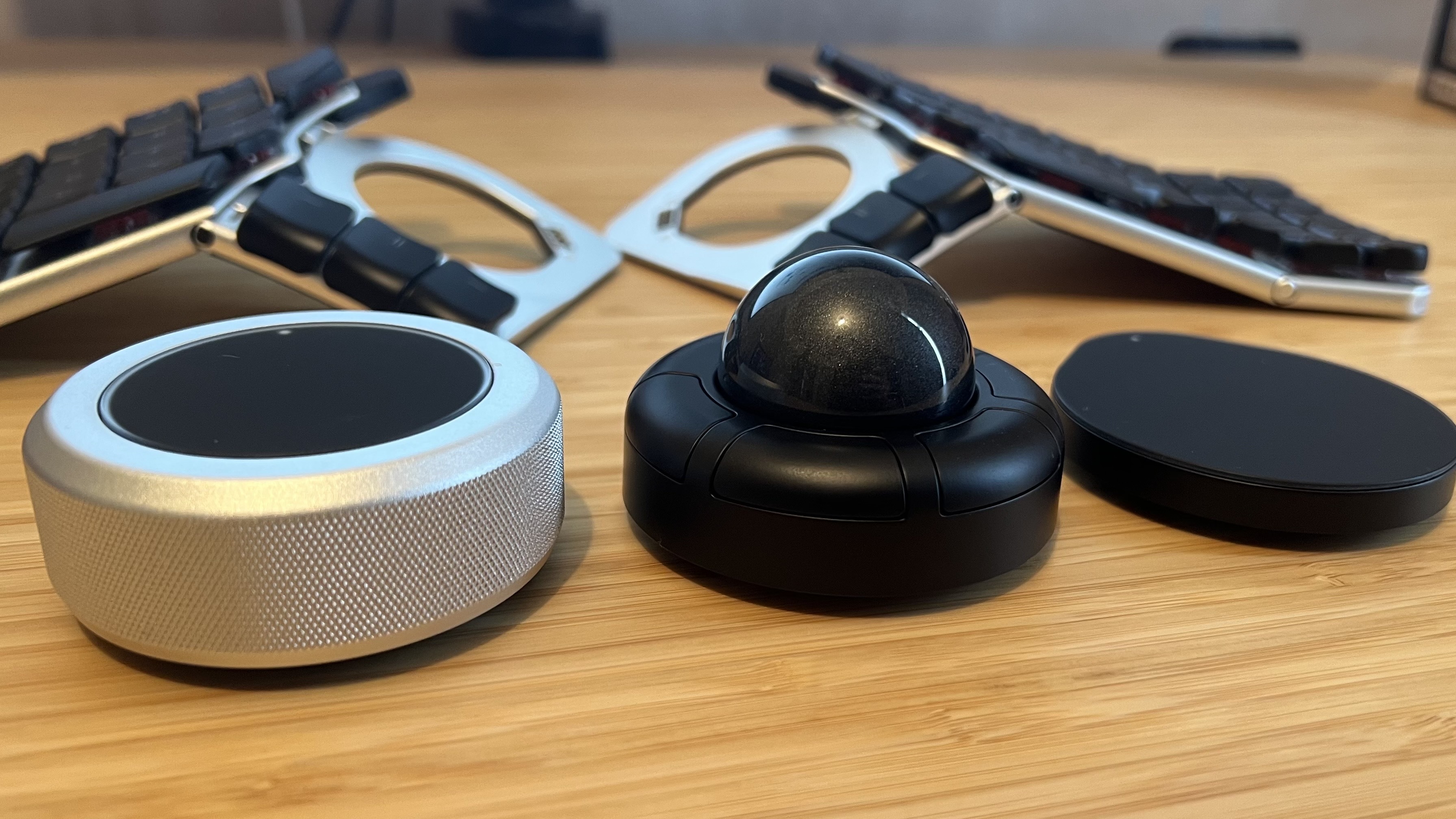 Naya Create Touch, Track, and Tune modules on a wooden desk in front of main keyboard