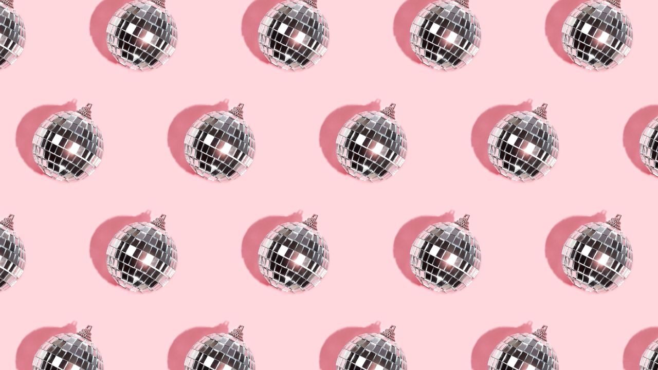 Rows of disco balls on a pink background