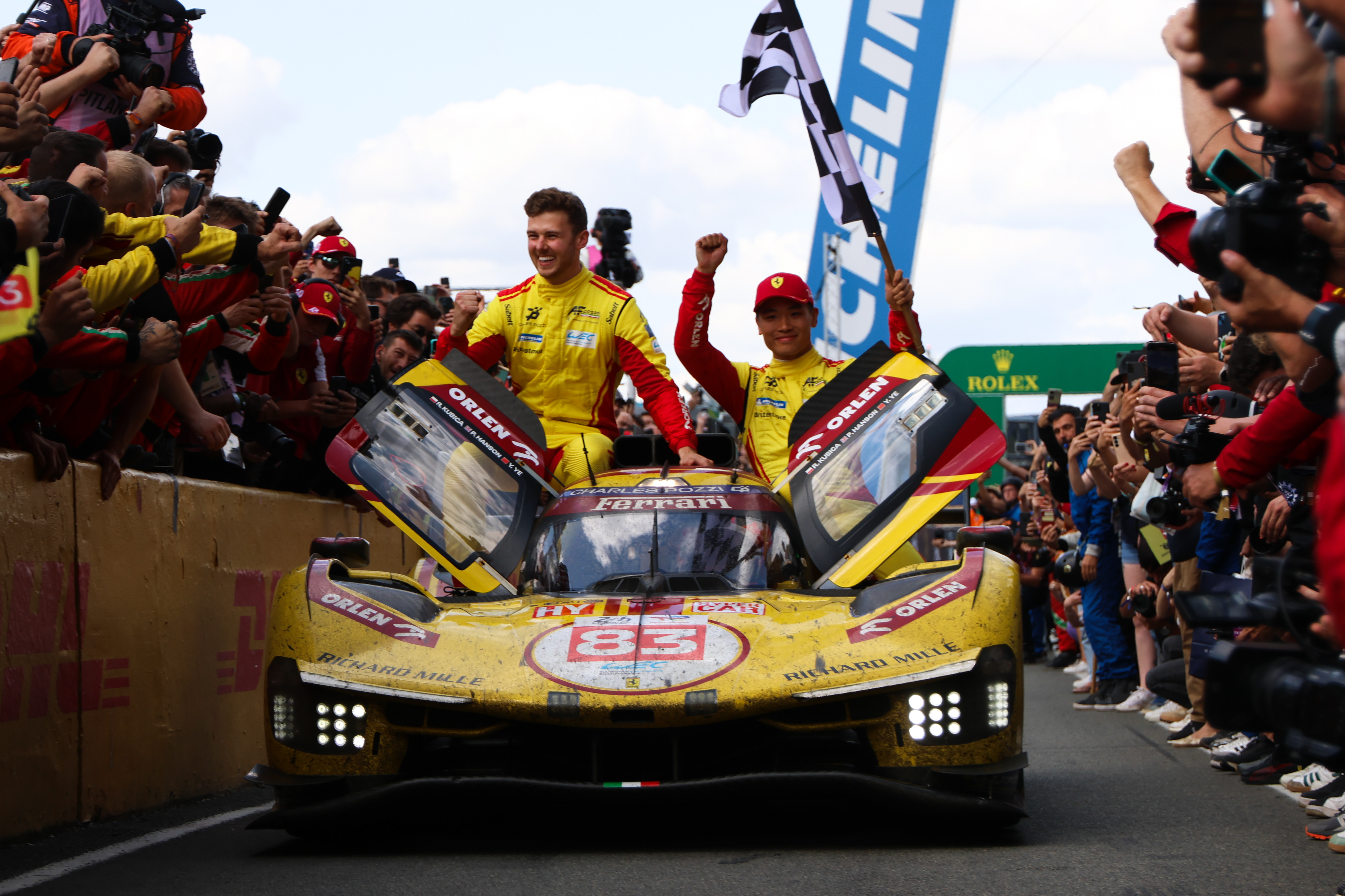 Phil Hanson and Yifei Ye celebrate winning Le Mans 2025 on the bonnet of their car
