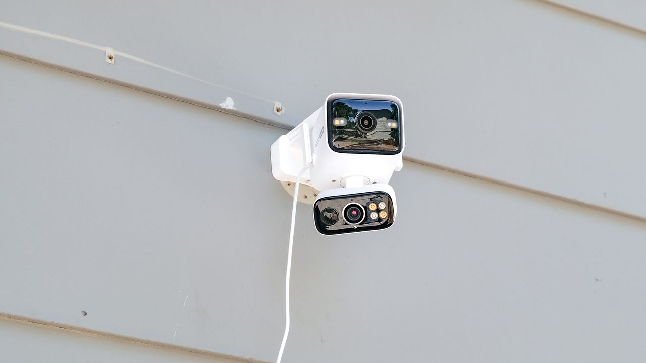 TP-Link Tapo C675D security camera mounted to the side of a house