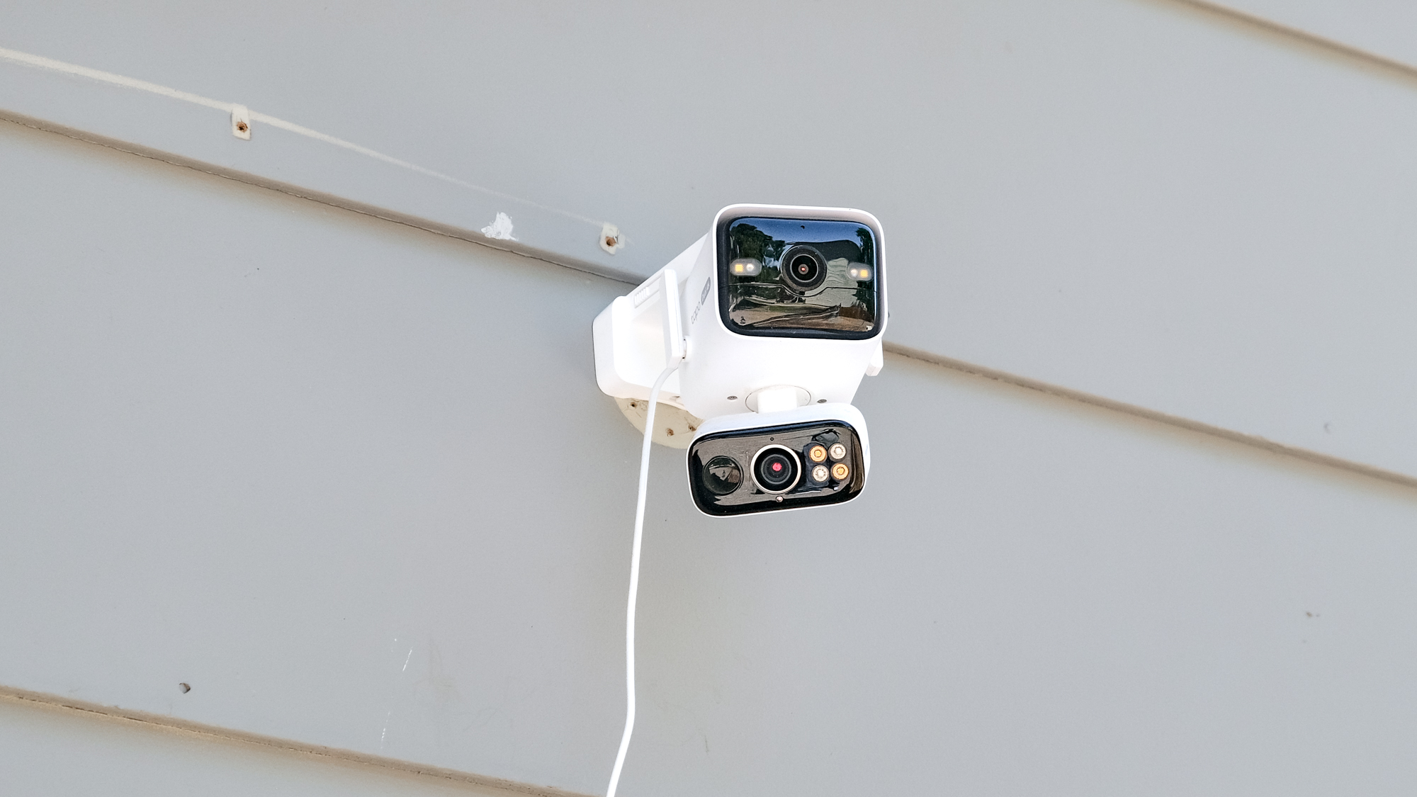 TP-Link Tapo C675D security camera mounted to the side of a house