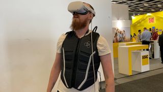Christian Guyton, TechRadar Computing Editor, wearing a haptic vest and VR headset at IFA 2023.