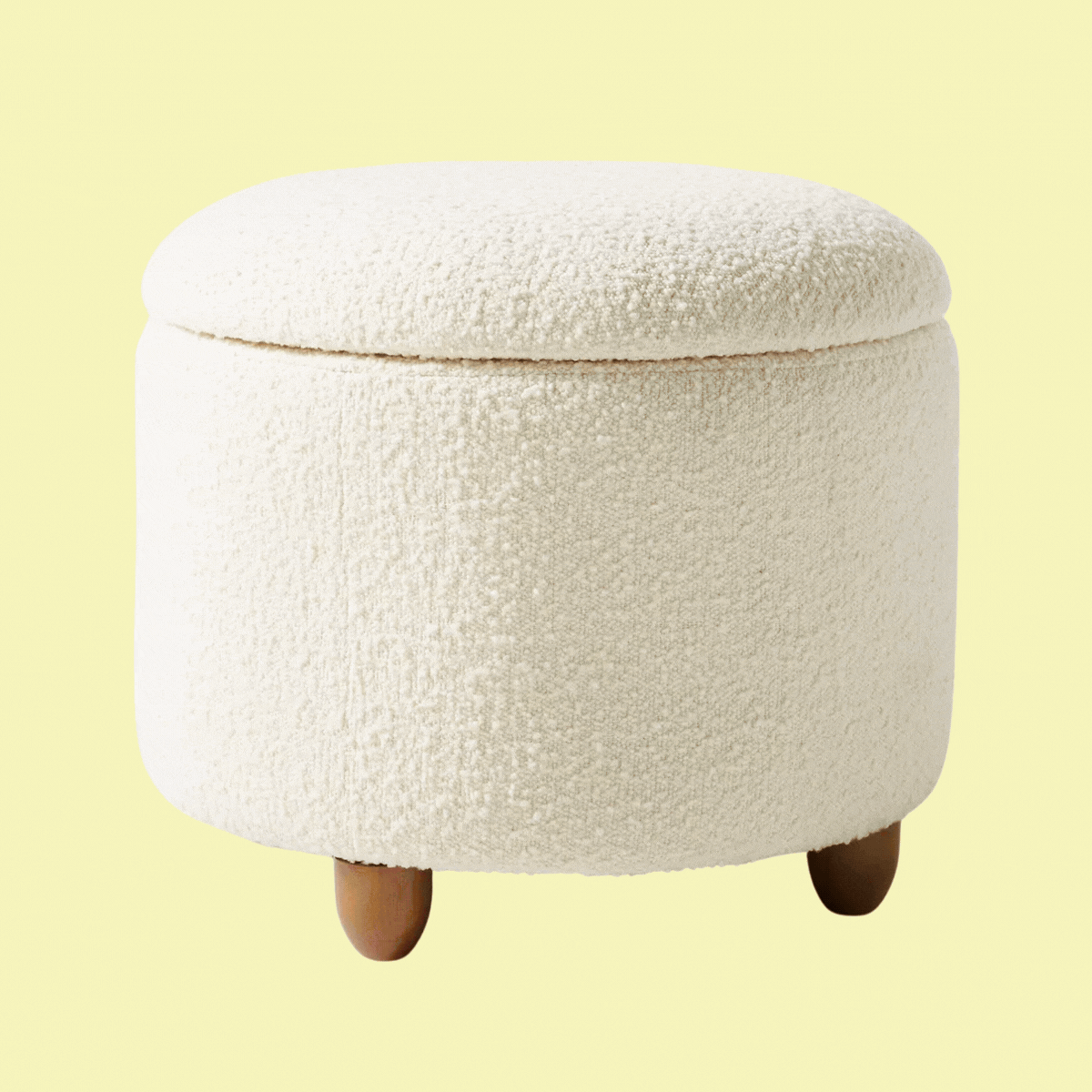 An ivory boucle storage ottoman
