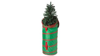 A green upright Christmas storage bag with red stripes halfway up a tree, for the best Christmas tree storage bags.