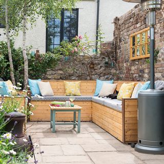 outdoor seating area with couch and flower plants