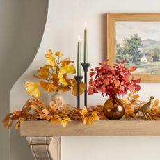Faux fall foliage stems on a mantle