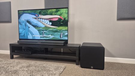 Q Acoustics Q Sub120 next to Marshall Heston 120 with TV playing The Boy and the Heron