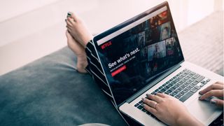 Woman watching Netflix on a laptop