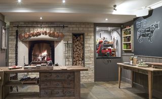 Interior of the Calcot Manor, Gloucestershire, UK with rustic wooden furniture, wood fire and blackboard