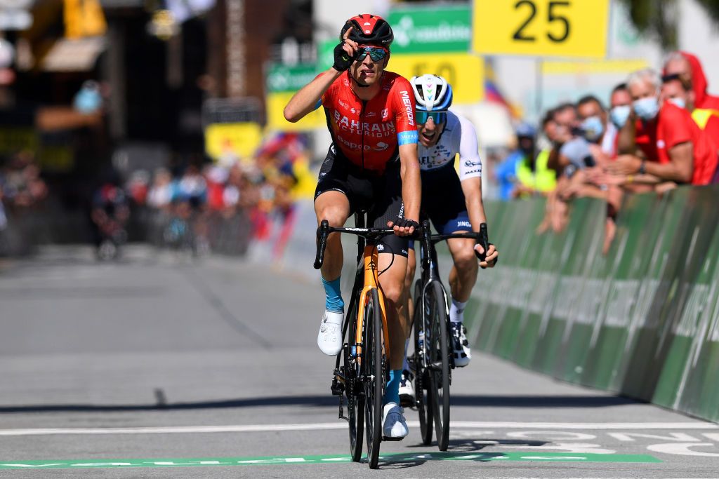 ANDERMATT SWITZERLAND JUNE 13 Gino Mder of Switzerland and Team Bahrain Victorious stage winner celebrates at arrival Michael Woods of Canada and Team Israel StartUp Nation during the 84th Tour de Suisse 2021 Stage 8 a 1595km stage from Andermatt to Andermatt UCIworldtour tds tourdesuisse on June 13 2021 in Andermatt Switzerland Photo by Tim de WaeleGetty Images