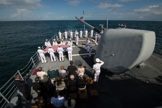 Family members of the late Neil Armstrong and members of the US Navy are seen during the burial at sea service for Neil Armstrong aboard the USS Philippine Sea (CG 58), Friday, Sept. 12, 2012, in the Atlantic Ocean.