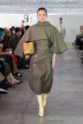 Model on the Jil Sander SS '24 runway show wearing an olive green outfit.