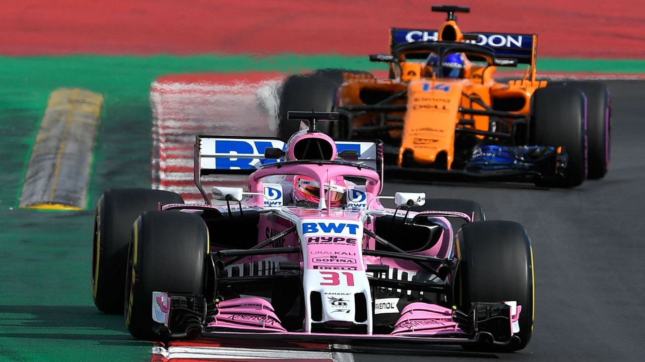 Esteban Ocon and Fernando Alonso drive during F1 pre-season testing in Barcelona in 2018 