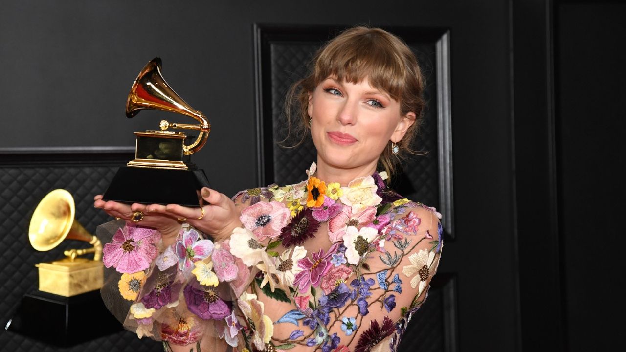 aylor Swift, winner of Album of the Year for &#039;Folklore&#039;, poses in the media room during the 63rd Annual GRAMMY Awards