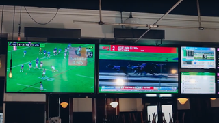 TV screens at a bar powered by Kramer AV solutions. 