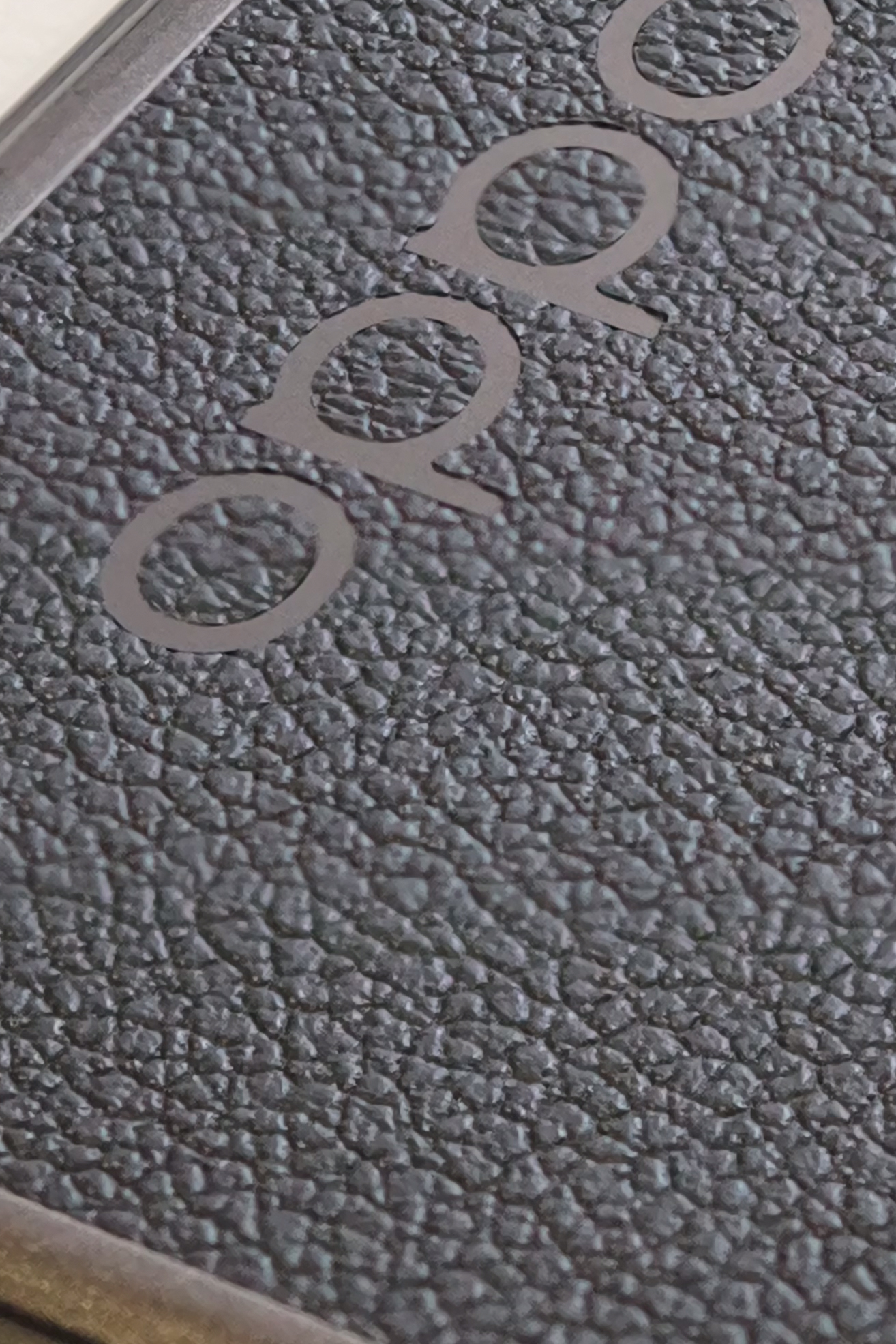 Extreme close-up showing the texture surrounding an Oppo logo.