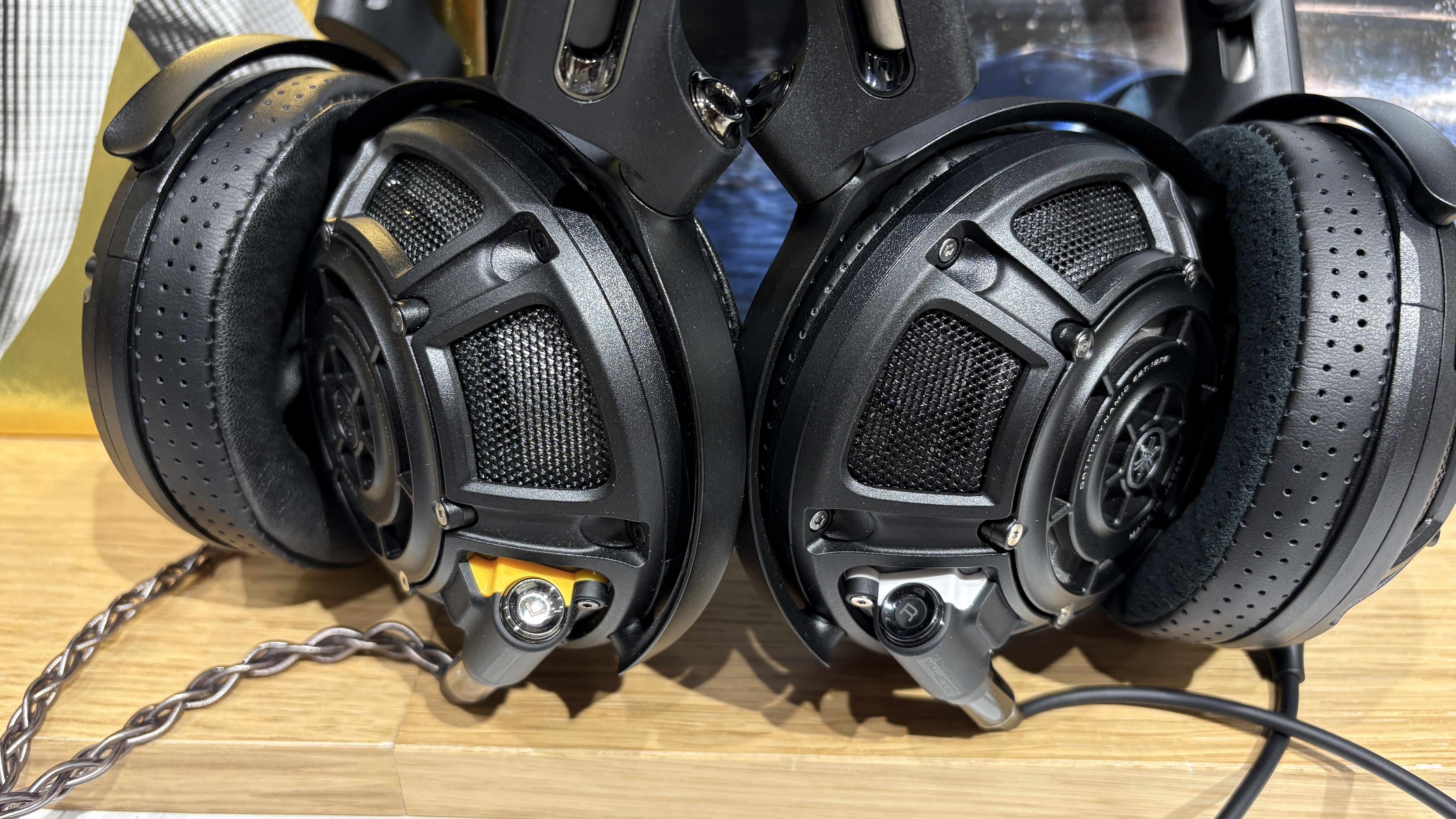 Yamaha YH-5000SE and YH-4000 headphones side-by-side on a desk with vinyl records in background