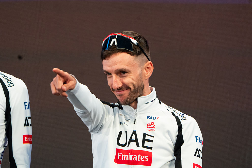 Adam Yates on the podium pointing to the crowd