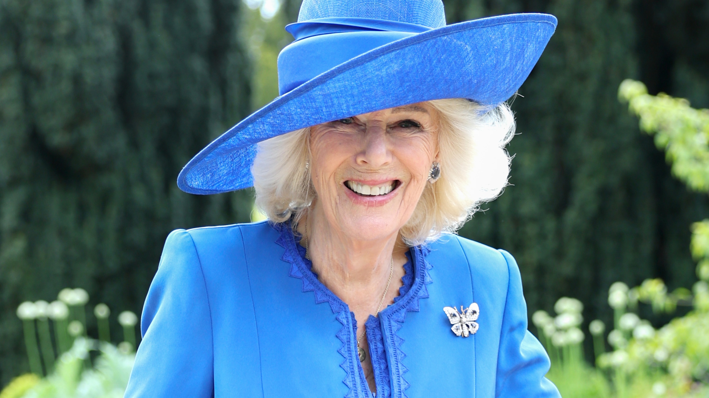Queen Camilla smiles as she poses during a Garden Party at Hillsborough Castle on May 20, 2026