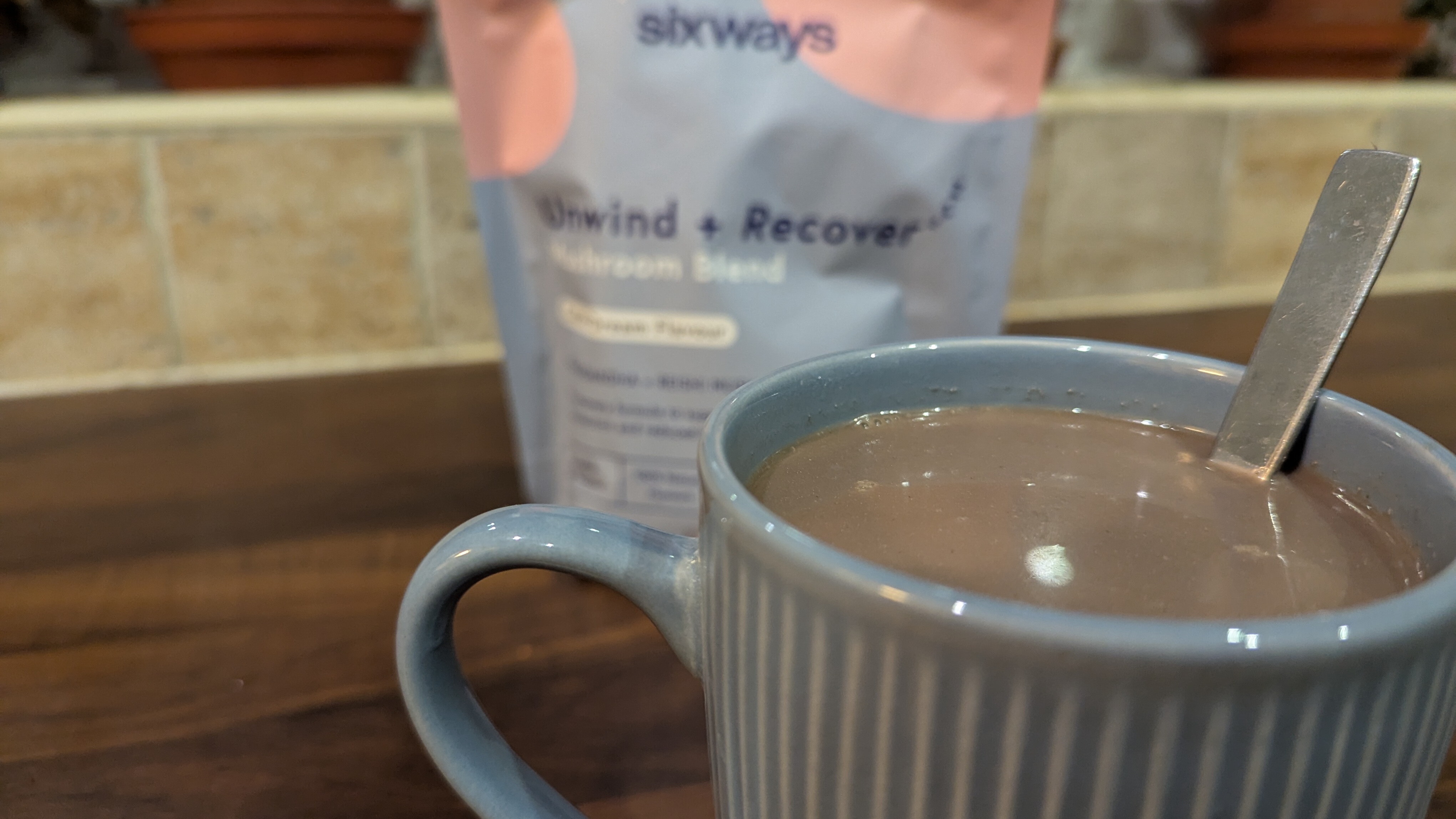 A close up of the mushroom hot chocolate with the pack seen in the background