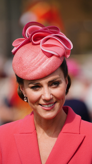 Catherine, Duchess of Cambridge speaks to guests at a Royal Garden Party at Buckingham Palace in London on May 18, 2022